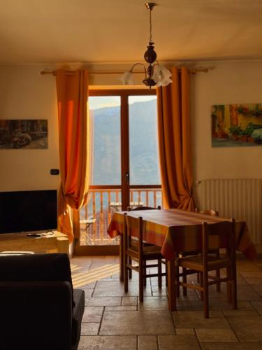 a dining room with a table and a large window at Sunrise Inn & Spa in Pessinetto