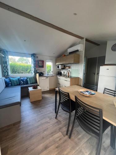una cucina e un soggiorno con tavolo e sedie di 538 mobile home grand confort a La Teste-de-Buch