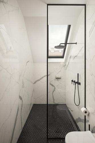 a bathroom with a shower and a toilet at Maison 45 - Luxury Boutique Hotel in Budapest