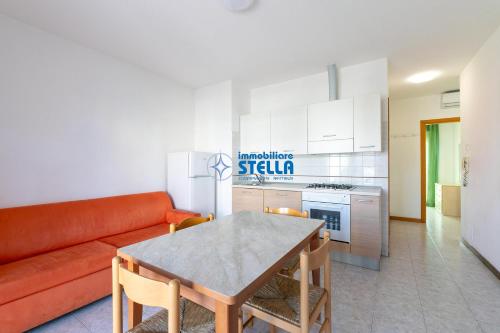 a living room with a couch and a table at Residence Adriatica in Lido di Jesolo