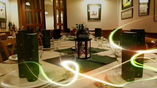 a long table with glasses and a lamp on it at Vadászkürt Panzió in Sopron