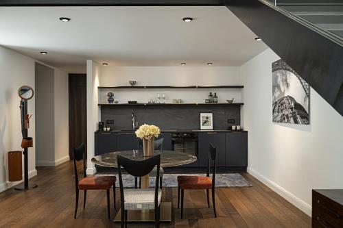 a kitchen and dining room with a table and chairs at Maison 45 - Luxury Boutique Hotel in Budapest