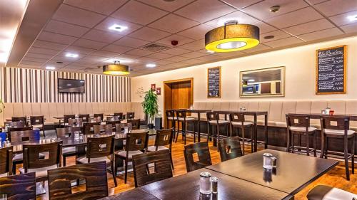 a dining room with tables and chairs in a restaurant at Parkhotel Olsberg in Olsberg
