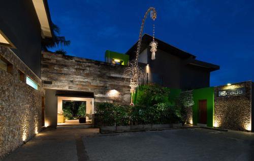 
a large stone building with a clock on it at Cicada Luxury Townhouses in Seminyak
