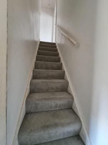 a staircase in a building with a stair case at The Oaks in Grays Thurrock