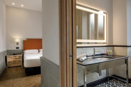 Ένα ή περισσότερα κρεβάτια σε δωμάτιο στο Hotel Morgana