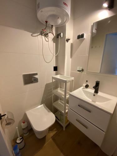 a bathroom with a white toilet and a sink at Avalon Lux in Sunny Beach
