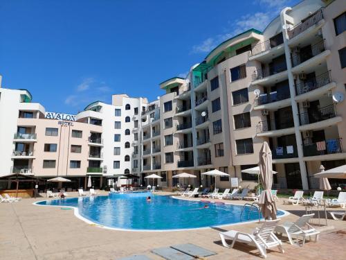 a swimming pool in front of some apartment buildings at Avalon Lux in Sunny Beach
