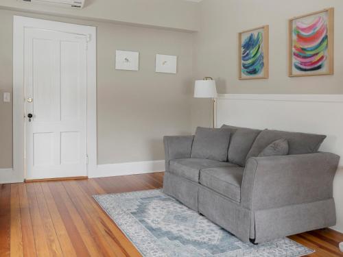a living room with a gray couch and a rug at Lakehouse Inn in Lee