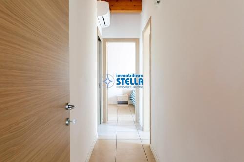 a hallway with a door and a sign that reads architecture stella at Residence Adriatica in Lido di Jesolo