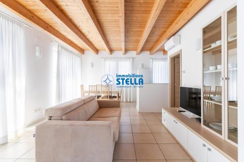 a living room with a couch and a tv at Residence Adriatica in Lido di Jesolo