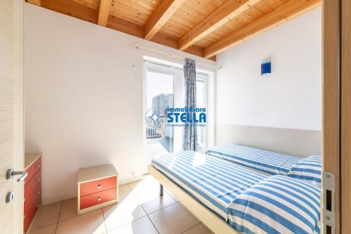 a bedroom with a bed and a window at Residence Adriatica in Lido di Jesolo