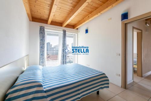 a bed in a room with a window at Residence Adriatica in Lido di Jesolo