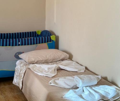 a bed with two pillows and two towels on it at Kontos Village House in Kondós