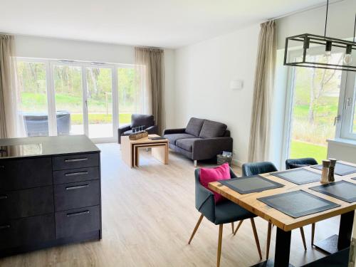 a kitchen and living room with a table and chairs at Villa Wattfuss in St. Peter-Ording