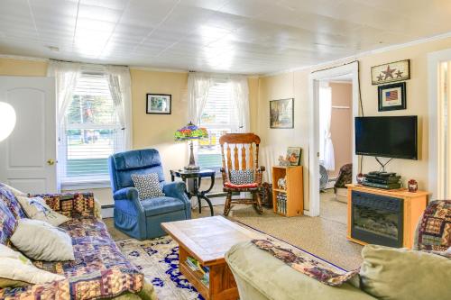a living room with a couch and chairs and a tv at Hunter Home with Fire Pit and Yard On Main Street! in Hunter