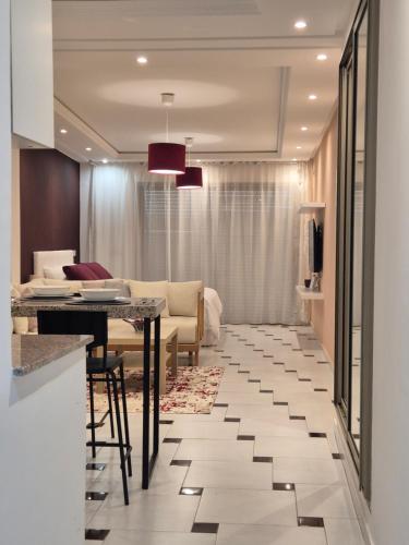 a living room with a table and a couch at RABAT Residence - AGDAL STAY in Rabat