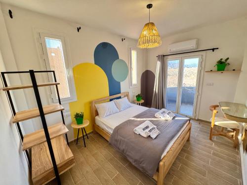a bedroom with a bed with a ladder and a table at Nomads Hostel in Dahab