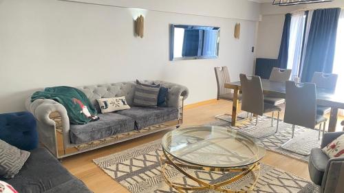 a living room with a couch and a table at Strelitzyahouse in Brussels