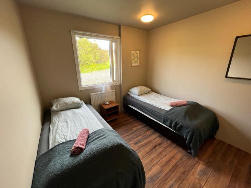 Una cama o camas en una habitación de Stóra-Mörk Guesthouse