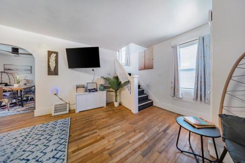 a living room with a staircase and a tv at Kenmore Akron 3 bedroom 1 bath in Akron