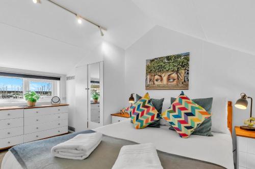 a white bedroom with a large bed and a window at On the Water 6 A One-of-a-Kind Stay Free Parking By My Getaways in Brighton & Hove