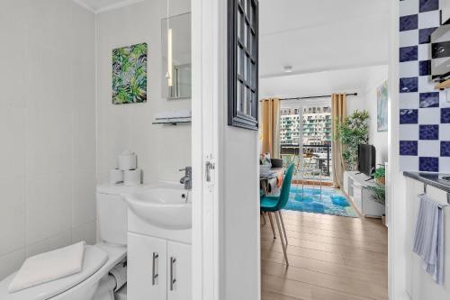 a white bathroom with a sink and a toilet at On the Water 6 A One-of-a-Kind Stay Free Parking By My Getaways in Brighton & Hove