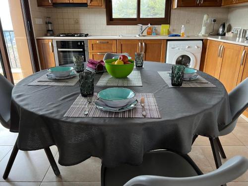 a table with a black table cloth on it in a kitchen at VILLa CALLIONE - AMAZING VIEW in Kyperounda