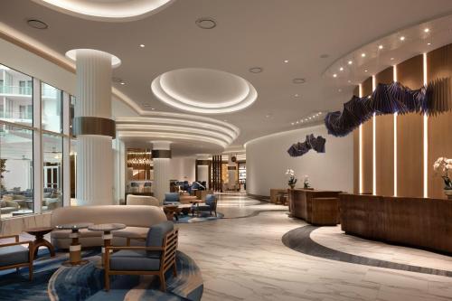 a lobby of a hotel with chairs and tables at Pier Sixty-Six in Fort Lauderdale