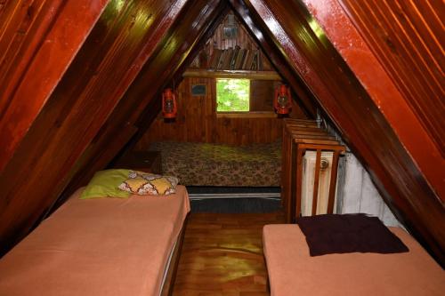 a small room with two beds and a window at Chata Mišo in Dubové