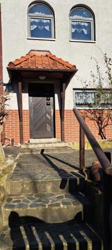 a building with a door with a roof at ! Ferienwohnung am Schlossberg in Blankenburg