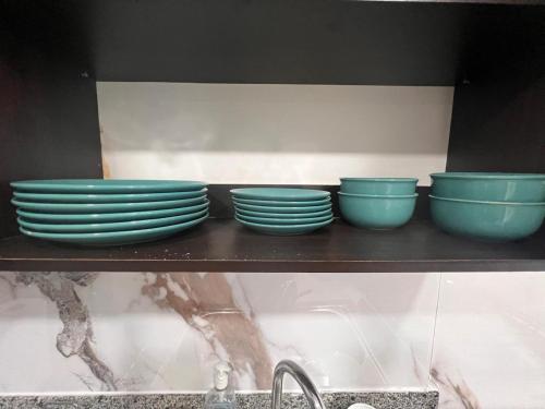a shelf with blue bowls and plates on it at Blue Dream in San Francisco in Panama City