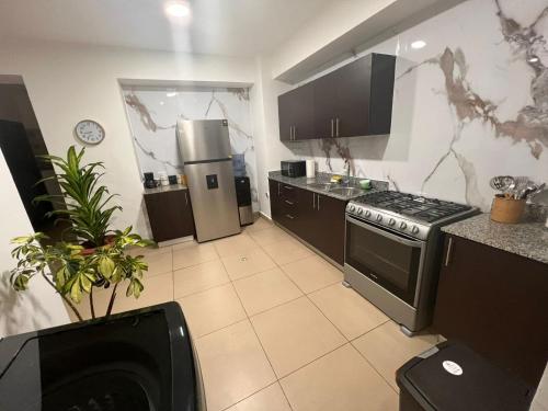 a kitchen with a stove and a refrigerator at Blue Dream in San Francisco in Panama City