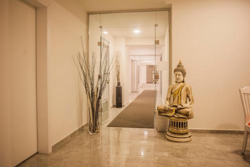 a statue of a buddha sitting in a room at Cimenoglu Hotel in Denizli