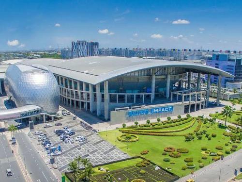 a large building in a city with a parking lot at My Happy Place in Nonthaburi
