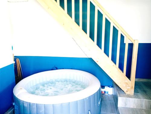 a bath tub in a room with a staircase at Magnifique bâtisse champenoise, jardins, billards, parking in Écury-sur-Coole