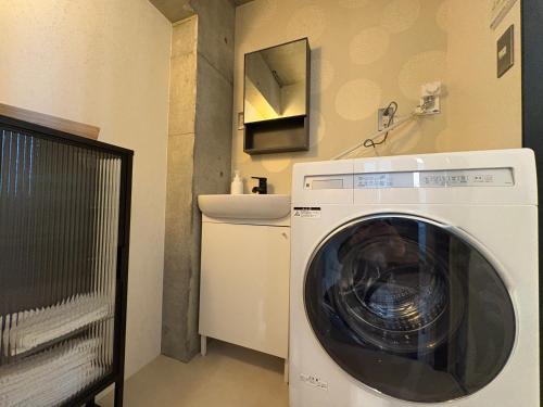 a washing machine in a bathroom with a sink at ShibuyaYoyogi Shinjuku 8psn 70sqm New Apartment Maisonette in Tokyo
