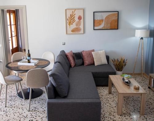 a living room with a couch and a table at Zefi's Aegina Apartment in Kapótidhes
