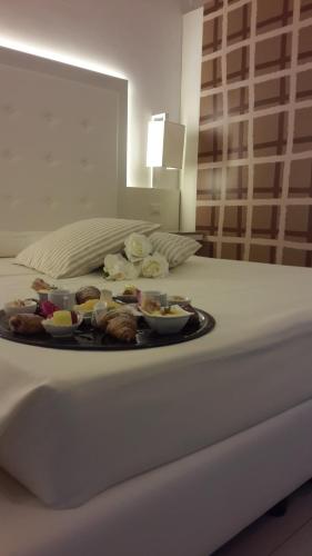a tray of food on top of a bed at Villa Principe Di Belmonte in Ispica