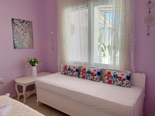 a small room with a bed and a window at AIR, Oneiropagida, Aegina in Vathí