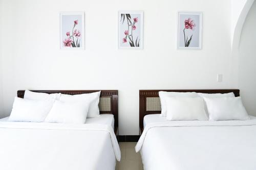Una cama o camas en una habitación de Horizon Côn Đảo Hotel