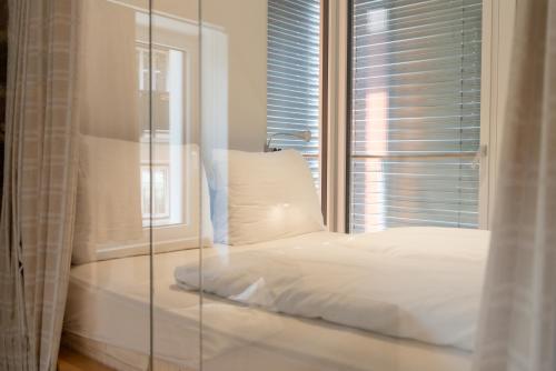a bed in a room with a glass window at Gardar in Bolzano