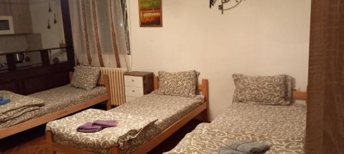 a room with two twin beds with towels on them at rm castell apartments in Novi Sad