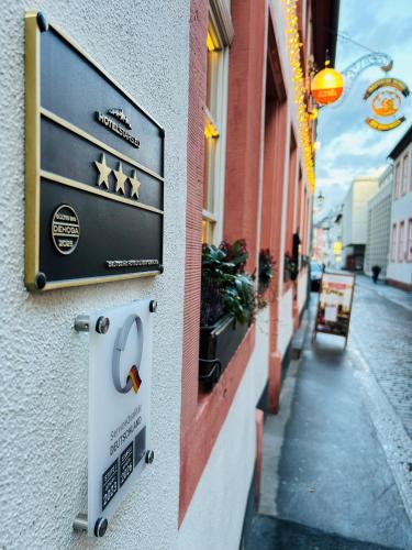 a sign on the side of a building on a street at Hof Ehrenfels in Mainz