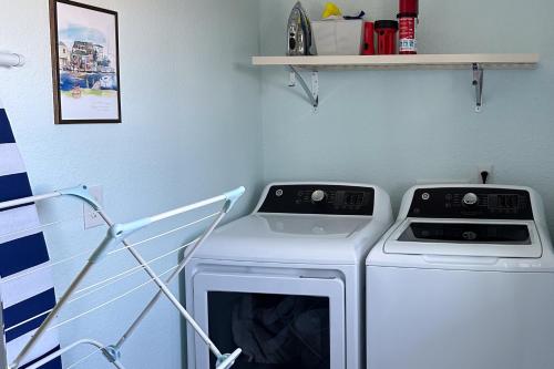 a laundry room with a washing machine and a shelf at Days to Remember in Avon