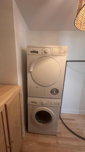 a washer and dryer with a washing machine in a room at Løvstræde apartments from 1 to 6 in Copenhagen