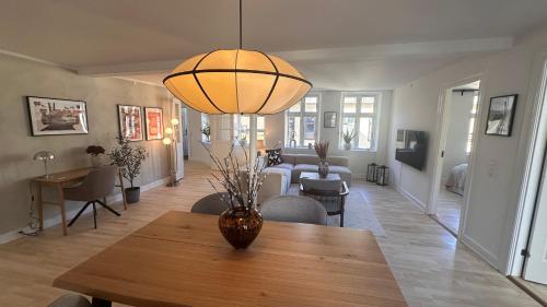 a living room with a vase on a wooden table at Løvstræde apartments from 1 to 6 in Copenhagen