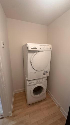 a washer and dryer in a corner of a room at Løvstræde apartments from 1 to 6 in Copenhagen