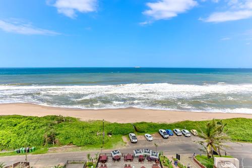 an aerial view of cars parked on the beach at Bali Hai 402 in Westbrook