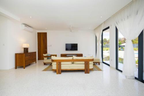 a living room with a couch and a table at Amkia Villas Diani in Diani Beach